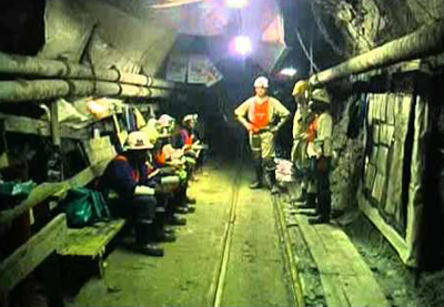 Miners in a passage deep inside a South African mine.