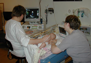 Sonographer performing pediatric echocardiography. Medical sonographer is a high-paying secure job