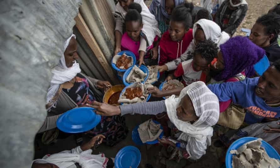 Displaced Tigrayans line up to receive food donated by local residents at a reception centre in Mekele, northern Ethiopia