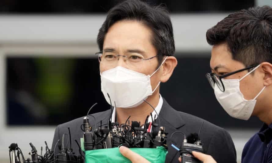 Lee Jae-yong speaking in front of a cluster of microphones.